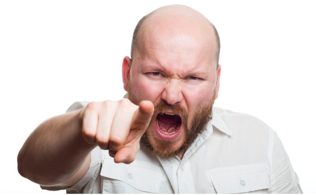 angry man pointing right index finger at you.